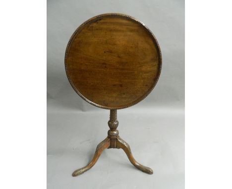 A 19th century oak and mahogany tilt-top tripod table. 53.5 cm diameter.