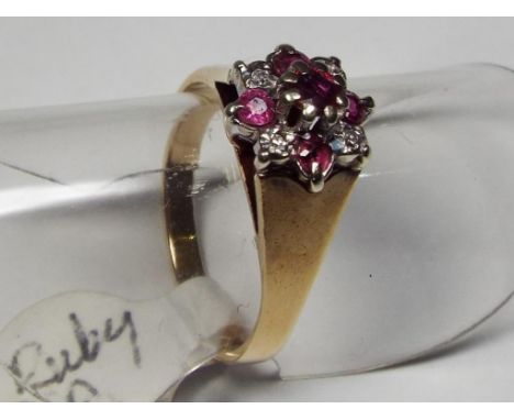 A lady's hallmarked 9 carat yellow gold cluster ring set with diamond and ruby, size J + 1/2, approx weight 2.87 gm, cased - 