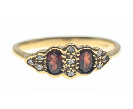 9ct gold ring set with orangey red paste and diamond accents. Size N 1/2. Gross weight 2.02g 