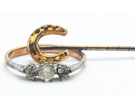 15ct gold horse shoe stick pin (1.18g) together with a paste set ring marked 9ct (1.63g). 