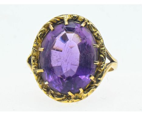 Amethyst set yellow metal ring. Oval mixed cut amethyst approximately 19mm x 14mm. Size T 1/2. Gross weight 4.99g. 
