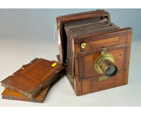 Wood encased plate camera dating to 1884 with brass f9 4.5mm lens and other brass furniture with two plate holders. Dimension