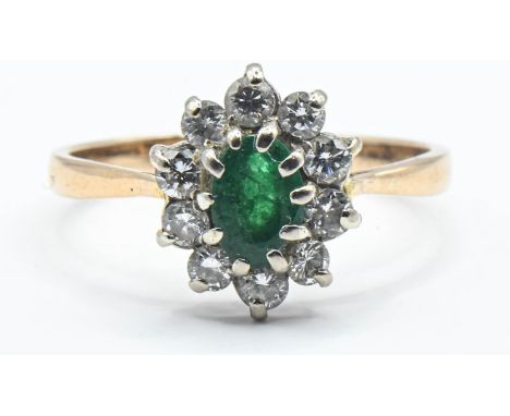 Emerald and diamond cluster ring on 18ct gold, size K. Gross weight 2.25g 
