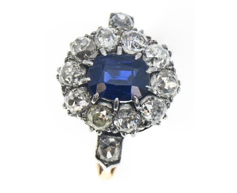 Sapphire and diamond halo cluster ring. The central rectangular cushion cut sapphire is approximately 1.77 carats and is surr