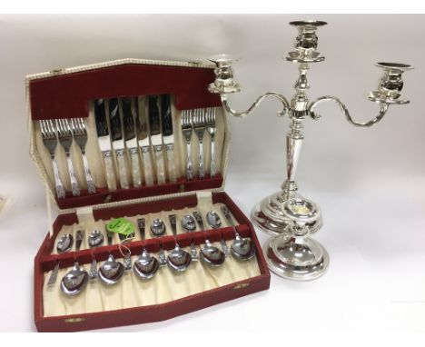 A three branch silver plated candlestick, chamber stick and cased canteen of cutlery plus an empty oak cased cutlery box (4).