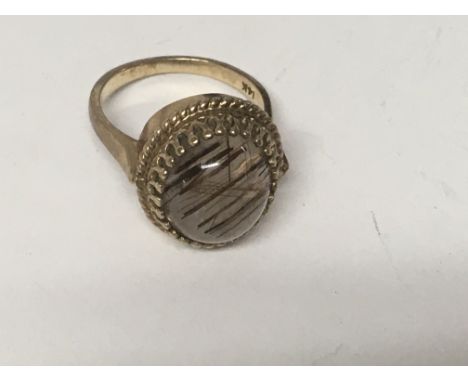 A 14 k gold ring inset with Crystal size O total weight 7 grams.