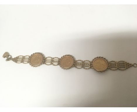 A 9carat gold gate bracelet inset with three half sovereigns total weight 22.5g approximately.