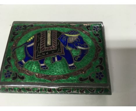 A silver and enamel pill box the hinged lid decorated with a elephant.