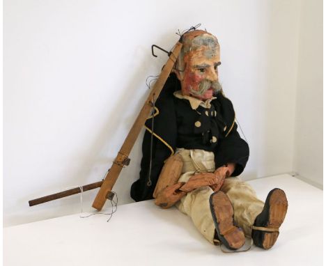 A late 19th/early 20th century handmade and painted wooden puppet in the form of an elderly sailor, dressed in traditional na