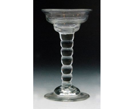 An 18th Century sweetmeat glass circa 1720, double ogee bowl above a seven section bobbin stem, raised on a domed foot, heigh