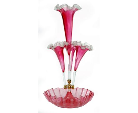 A late 19th Century Stourbridge ruby glass epergne with a deep frill rim bowl rising to a tall central trumpet with applied c