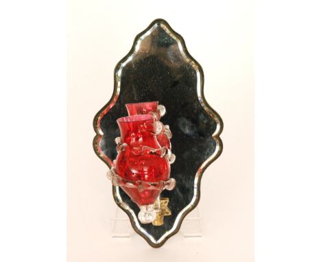 A late 19th Century Stourbridge glass girondal wall mirror with a bevelled edge shield shape mirror mounted with a single rub