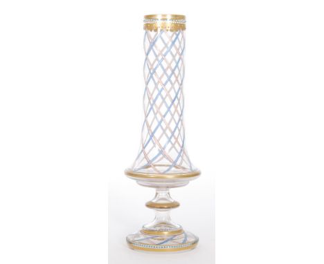 A late 19th Century Bohemian glass vase possibly by Moser, of tapered sleeve form raised on a knopped stem and conical foot, 