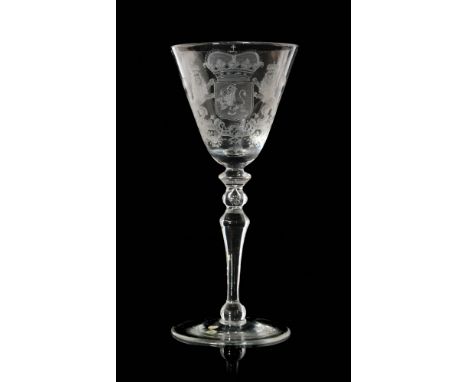 An 18th Century Newcastle light baluster wine glass circa 1750, the large round funnel bowl engraved with the Arms of Holland