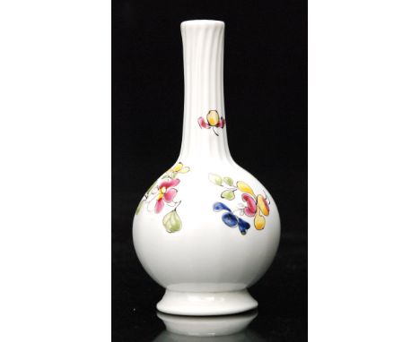 An 18th Century opaque white glass vase circa 1770 of footed globe and shaft form with coloured enamel floral decoration over