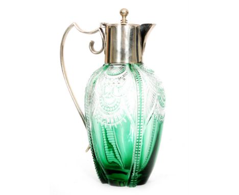 An early 20th Century Stevens and Williams glass claret jug of drawn ovoid form below silver plated mounts, cased in green ov