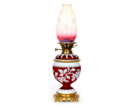 A late 19th Century cameo glass oil lamp by John Walsh Walsh. The pedestal ovoid body mounted on a classically decorated bras