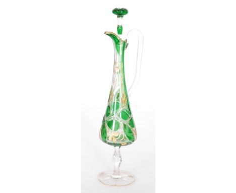 A late 19th Century Moser glass liqueur decanter, the circular foot rising to a swollen faceted stem below a conical body wit