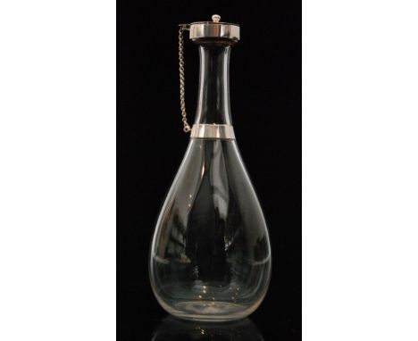 A late 19th Century crystal glass decanter designed by Dr Christopher Dresser of tapered bottle form with applied silver plat