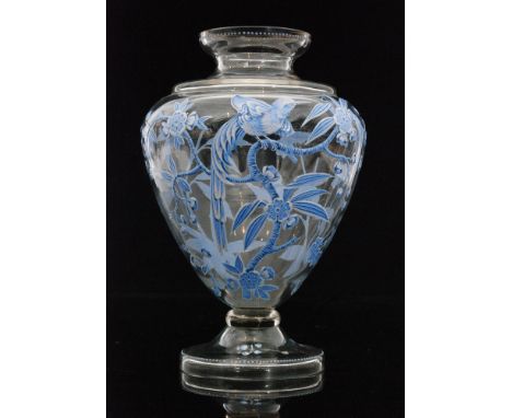 A late 19th Century French glass vase of footed shouldered form, decorated with a relief enamelled exotic bird amongst branch