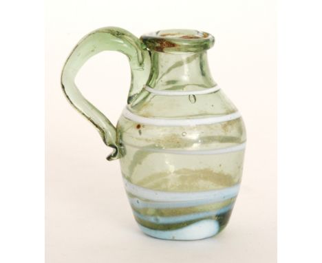 An early 19th Century Nailsea miniature glass jug with applied scroll kick handle, decorated with a wrythen opal trail to the