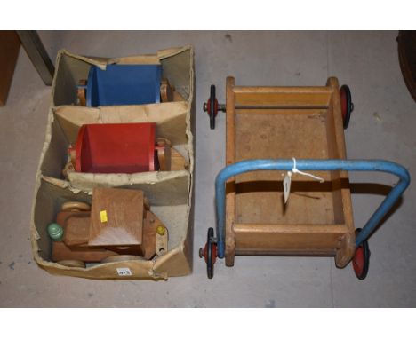 A Tri-ang baby walker; together with a wooden toy train and two carriages.