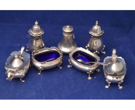 A George V silver condiment set, by Walker &amp; Hall, Birmingham 1929, comprising: table salt, mustard pot with spoon and pe