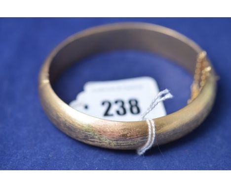 A yellow metal bangle, stamped '750', 36.8g.