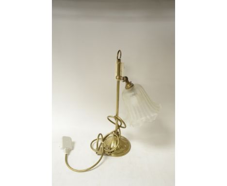 A Brass table lamp with glass shade.