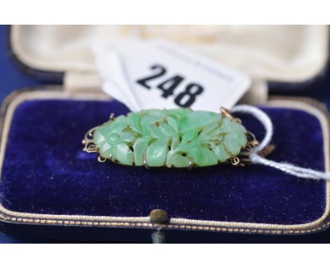 A Chinese Jade coloured stone brooch, of leaf design, in white metal mount.