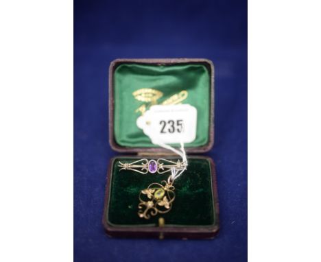 An Edwardian peridot and seed pearl pendant; and an amethyst brooch.