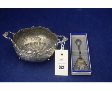A Dutch silver caddy spoon, with embossed decoration, in original box; and a white metal two-handled bowl, hallmarks to base,