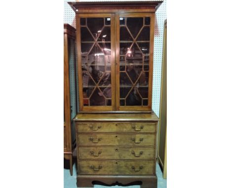 A George III inlaid mahogany bookcase chest, with a pair of glazed doors over four long graduated drawers on bracket feet, 10