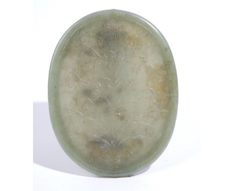 A celadon jade oval mirror frame, probably Mughal India, 18th/19th century, the back carved in low relief with a flowering pl