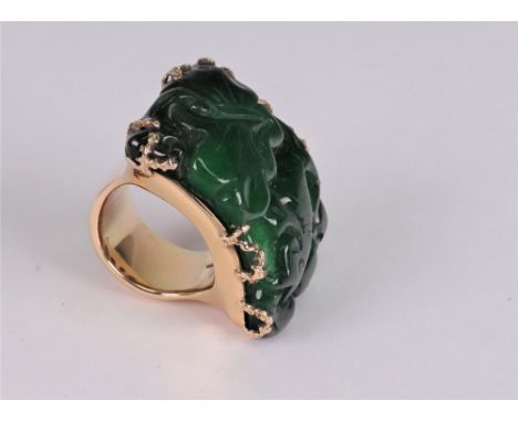 Carved jadeite dress ring of arched plaque design, the rectangular jadeite plaque carved with carp, claw set to a yellow prec