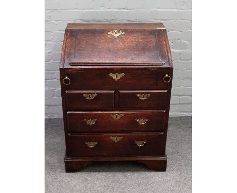 A small 18th century oak bureau, the stepped and welled interior over two short and two long drawers on bracket feet, 66cm wi