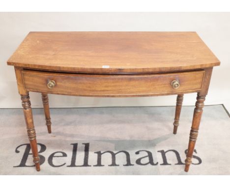 A late Victorian mahogany bowfront two drawer side table on ring turned supports, 106cm wide x 78cm high. 