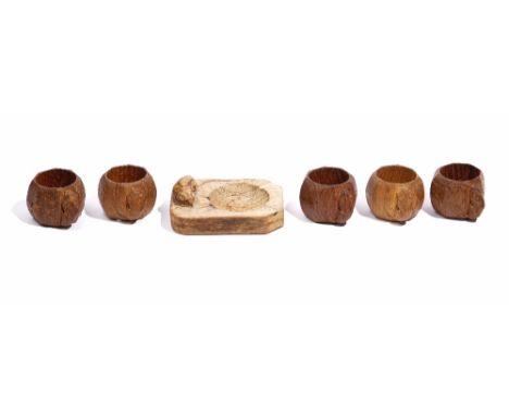 ROBERT THOMPSON 'The Mouseman' five octagonal oak napkin rings, each carved with a mouse and a rectangular cut-cornered ashtr