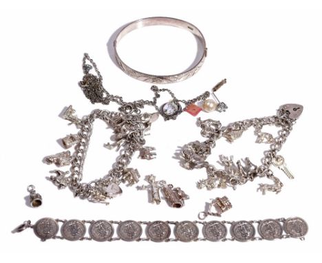 A silver curb link charm bracelet, fitted with eleven charms, including a crocodile, a horse and a key, on a silver heart sha