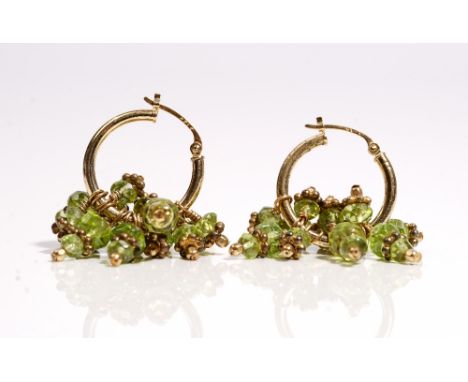 A pair of gold and faceted peridot bead earrings, each circular earring with faceted peridot bead drops, detailed 14 K, gross