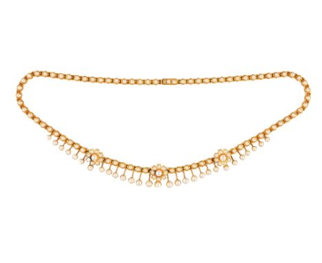 An Edwardian gold and half pearl set collar necklace, the front with three flowerhead motifs at intervals and otherwise with 