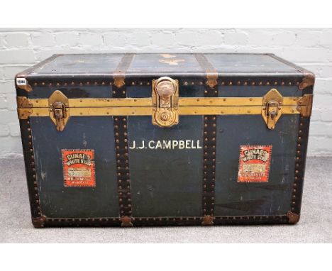 An early 20th century brass and metal bound travelling trunk with Cunard, White Star labelling, 100cm wide x 59cm high. 
