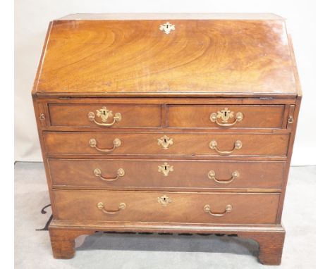 A George III mahogany bureau with two short over three long graduated drawers on bracket feet, 98cm wide x 100cm high. 