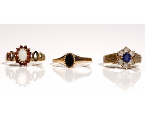 A 9ct gold, opal and garnet set oval cluster ring, decorated with pierced shoulders, ring size N and a half, a 9ct gold, blue