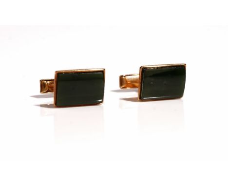 A pair of gold mounted New Zealand jade cufflinks, with curved rectangular fronts and with folding bar fittings at the backs,