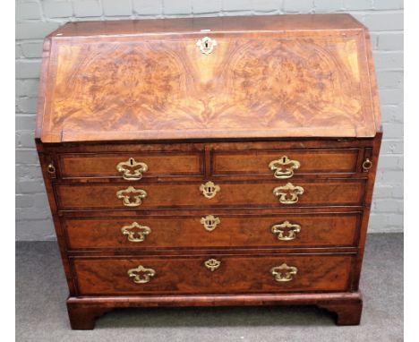 A mid-18th century feather banded figured walnut bureau, the fitted interior over four long graduated drawers, on bracket fee