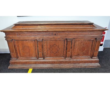 A 16th century Italian marquetry inlaid walnut and fruitwood cassone, the raised lift caddy top over triple panelled front di