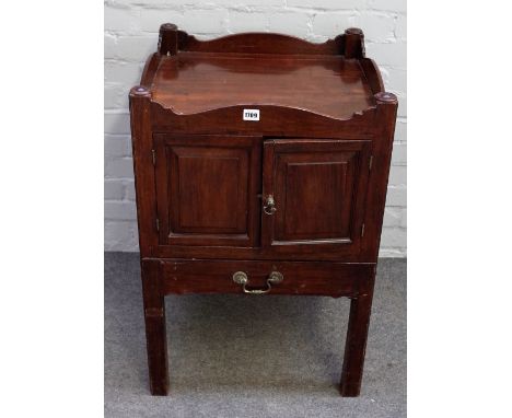A George III mahogany tray top night commode, enclosed by a pair of raised and fielded panel doors with an altered pull-out s