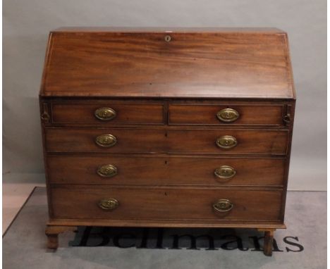 A George III mahogany bureau with two short and three long graduated drawers on bracket feet, 121cm wide x 111cm high. 