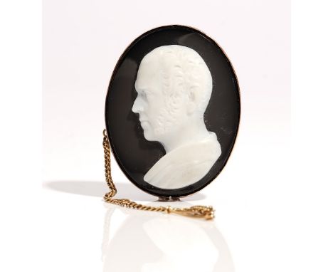 An oval carved agate cameo brooch, designed as the portrait of a gentleman, within an undecorated setting, fitted with a safe